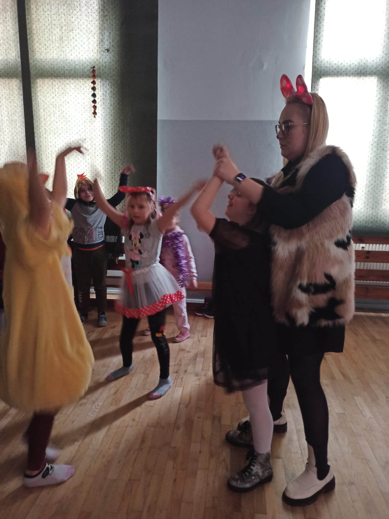 Na środku znajduje się grupa osób