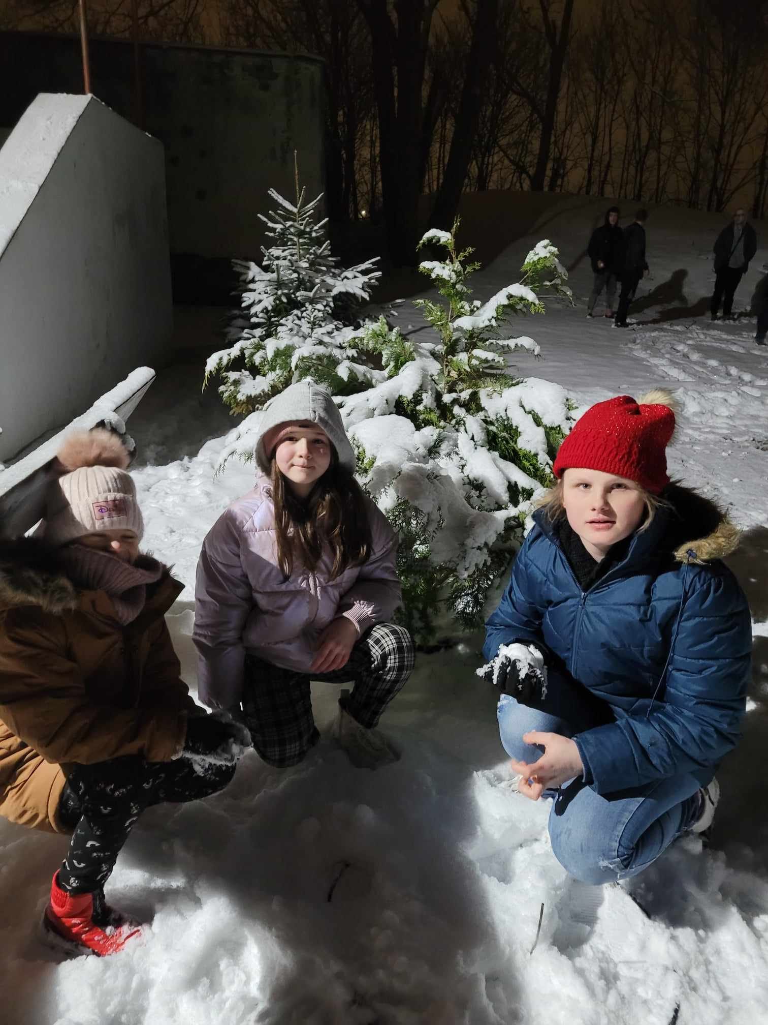Na śniegu znajduje się grupa osób